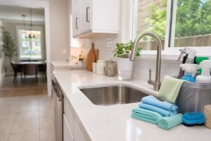 Sparkling clean kitchen after a deep cleaning day in Houston home with supplies on counter